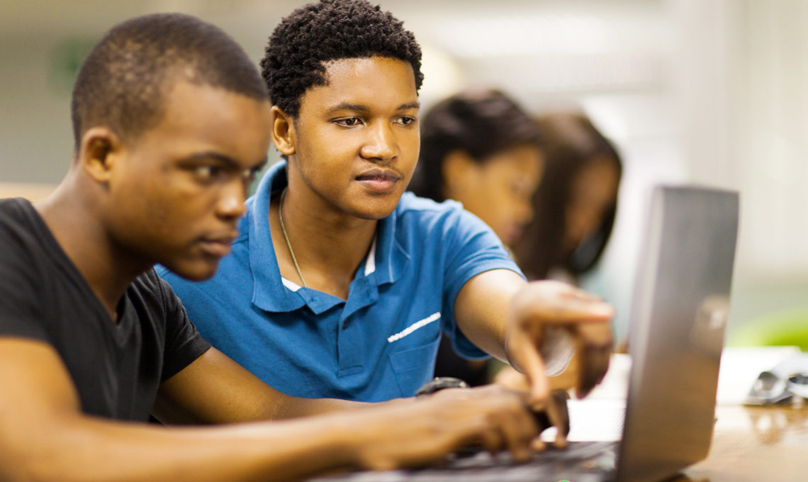 Young African men using laptop to learn online